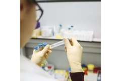 Image Scientist holding an experiment tube.